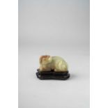 A CHINESE YELLOW AND RUSSET JADE CARVING OF A MYTHICAL BEAST QING DYNASTY The beast depicted