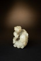 A RARE CHINESE CREAMY-WHITE JADE CHIMERA SONG-MING DYNASTY The chimera is strongly carved and seated