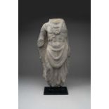 A GANDHARAN GREY SCHIST TORSO OF A BODHISATTVA 2ND/3RD CENTURY AD Carved standing in a
