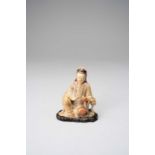 †A RARE CHINESE SOAPSTONE FIGURE OF GUANYIN KANGXI 1662-1722 The Goddess sits in a position of