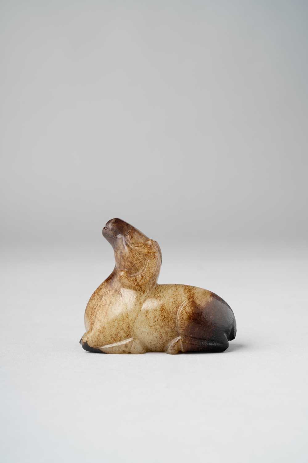 A CHINESE JADE CARVING OF A RAM QING DYNASTY Recumbent with its head raised and tilted back, the