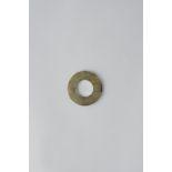A CHINESE JADE DISC, BI HAN DYNASTY OR EARLIER The celadon-coloured stone with brown streaks and