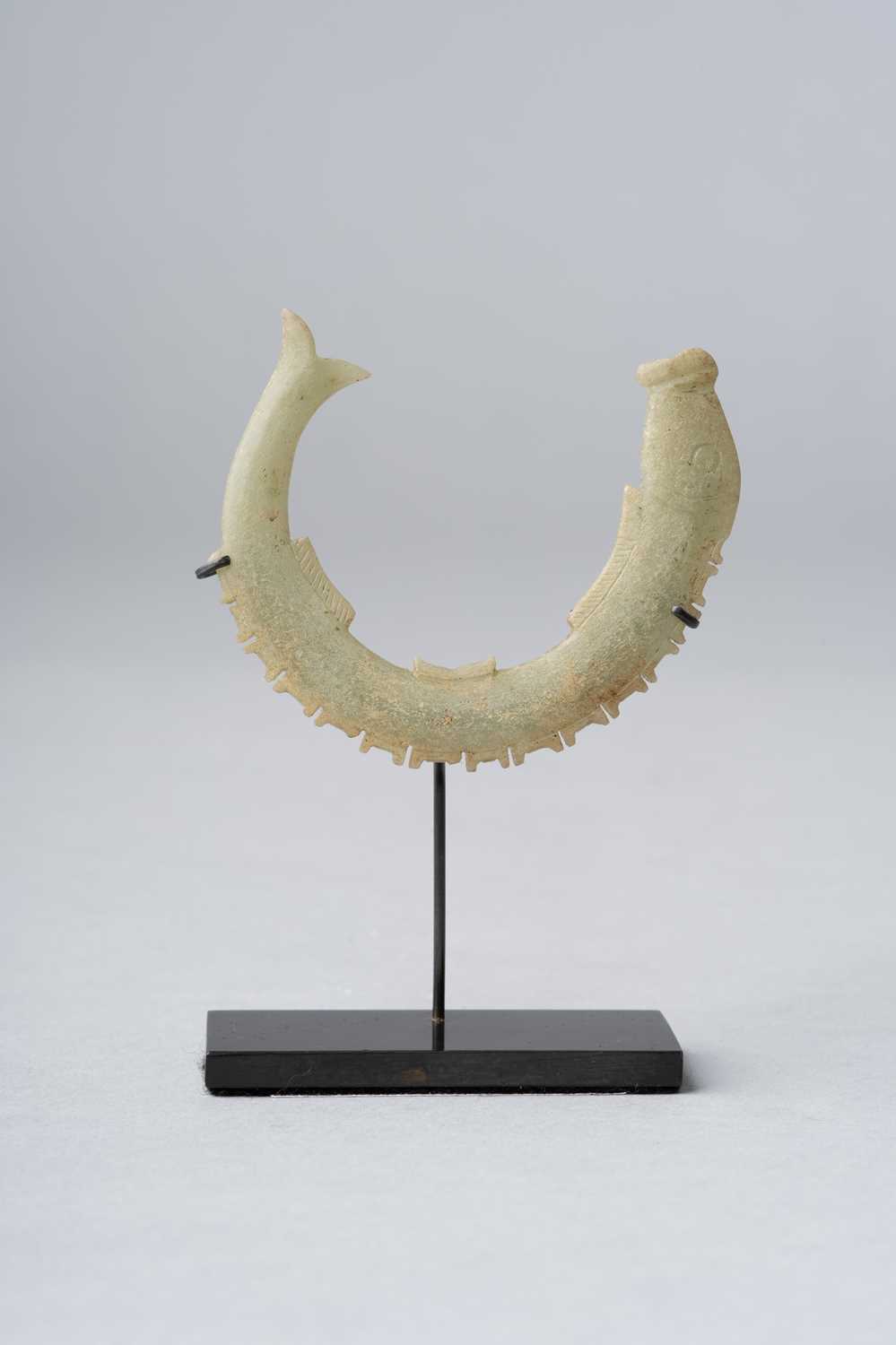 A CHINESE CELADON JADE ARCHAIC 'FISH' PENDANT SHANG/WESTERN ZHOU DYNASTY OR LATER Carved as a