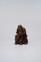 A CHINESE BAMBOO FIGURE OF A LUOHAN AND A BUDDHIST LION 18TH CENTURY The figure seated on a