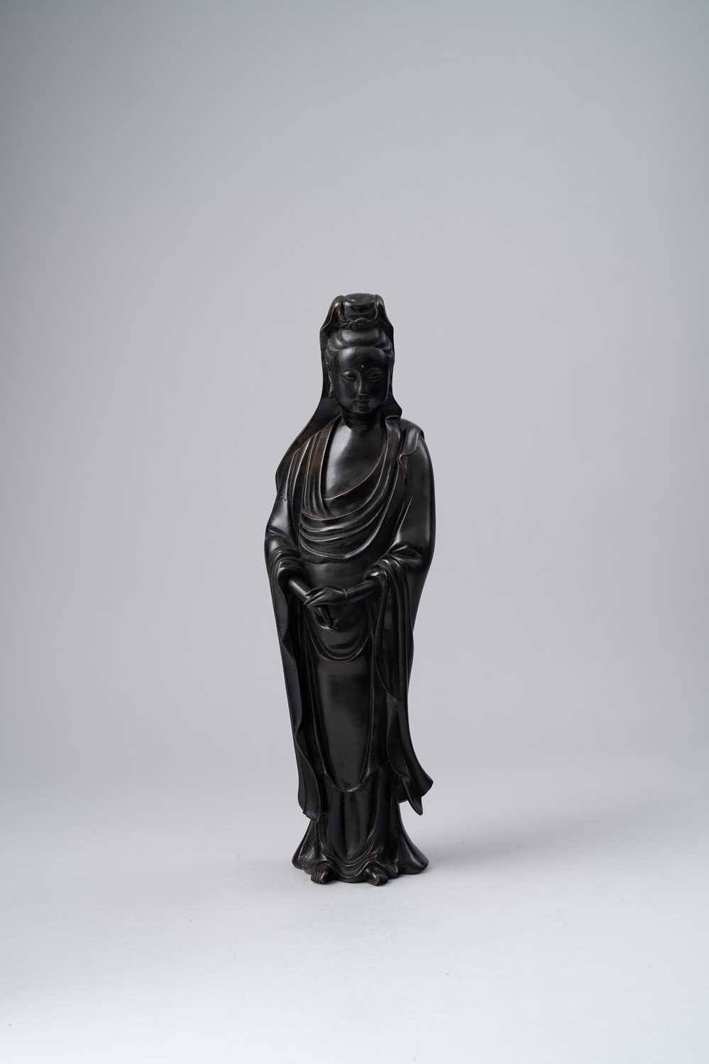 A CHINESE SILVER-INLAID 'SHI SOU' STYLE BRONZE FIGURE OF GUANYIN LATE MING DYNASTY Standing with