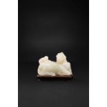 A CHINESE WHITE JADE 'MONKEY AND HORSE' GROUP 18TH CENTURY Carved in the form of a recumbent