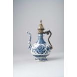 A CHINESE BLUE AND WHITE EWER WITH MIDDLE-EASTERN GILT-COPPER MOUNTS 17TH/18TH CENTURY The pear-