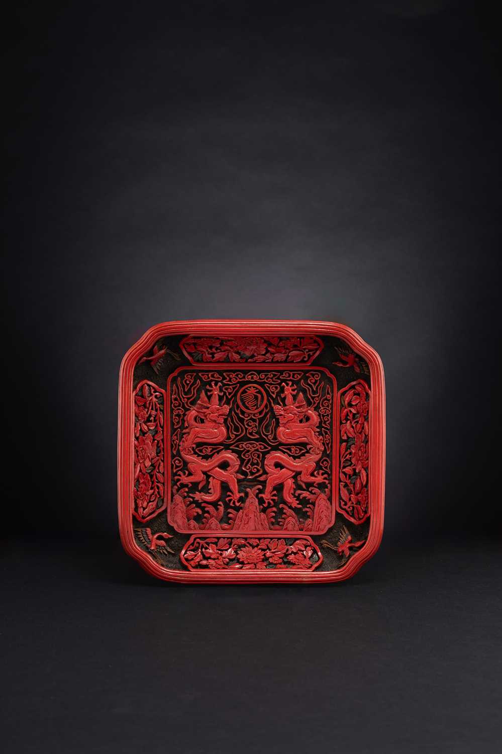 A RARE CHINESE THREE-COLOURED LACQUER 'DRAGON' TRAY QIANLONG 1736-95 The square dish decorated to