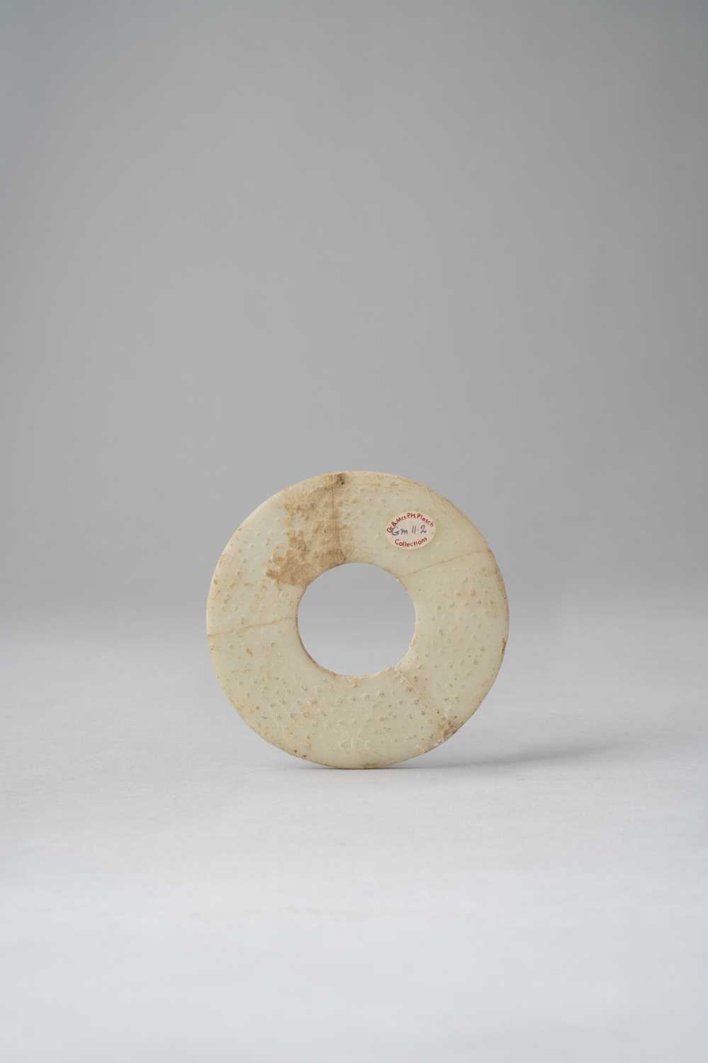 TWO CHINESE GLASS DISCS, BI HAN DYNASTY The smaller with a buff/off-white opaque surface, - Image 2 of 3