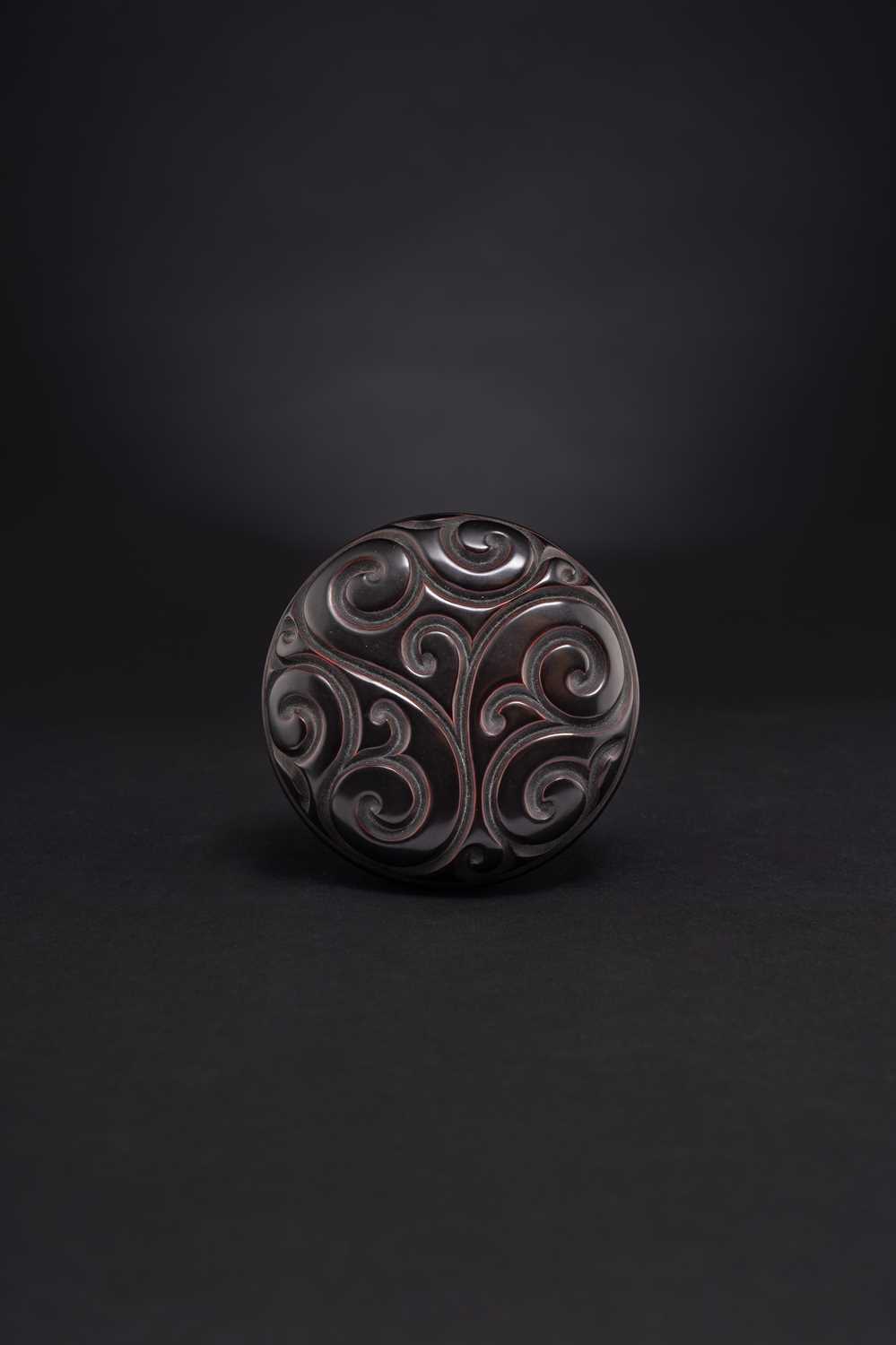 A CHINESE BLACK TIXI LACQUER BOX AND COVER MING DYNASTY The circular box and cover carved with