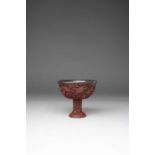 A CHINESE YUNNAN-TYPE CINNABAR LACQUER STEM CUP LATE MING DYNASTY Carved with four magpies among