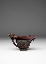 λ A CHINESE ARCHAISTIC RHINOCEROS HORN ‘CHILONG’ LIBATION CUP 17TH/18TH CENTURY The body carved in