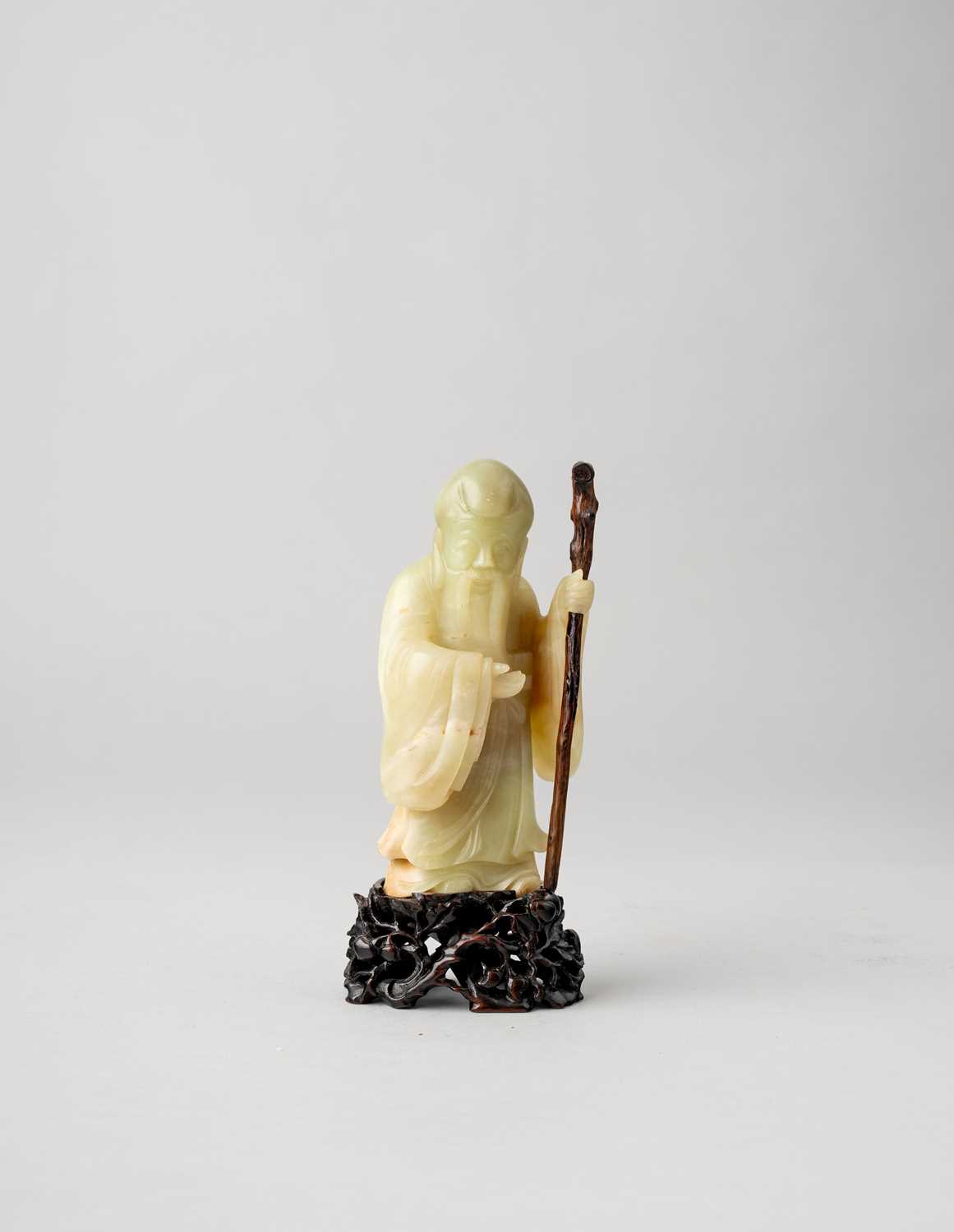 A CHINESE YELLOW JADE CARVING OF SHOULAO 18TH CENTURY The smiling deity wearing flowing robes