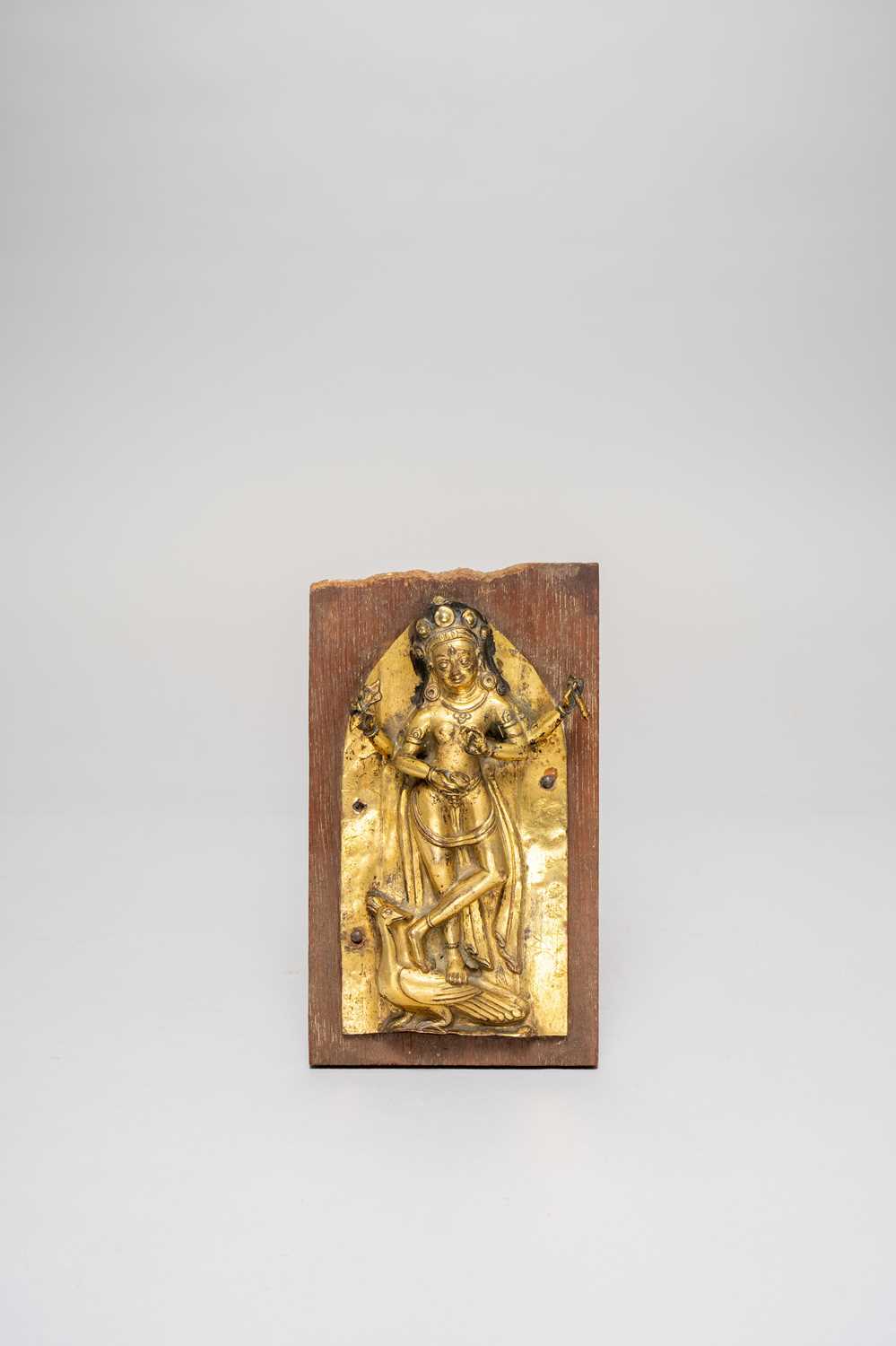A NEPALESE GILT-COPPER REPOUSSE PLAQUE DEPICTING KAUMARI 17TH CENTURY The four-armed Goddess Kaumari