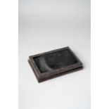 A LARGE CHINESE DUAN STONE INKSTONE QING DYNASTY Of rectangular form with archaistic strapwork and