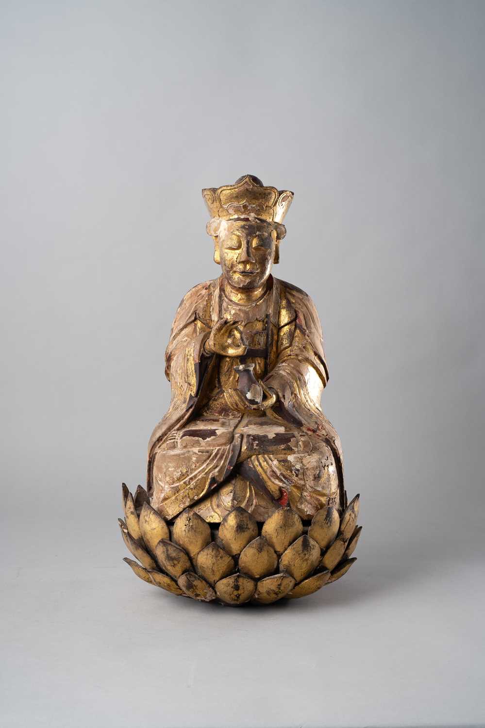 A LARGE CHINESE GILT-WOOD FIGURE OF A DAOIST IMMORTAL MING DYNASTY Depicting the deity sitting in