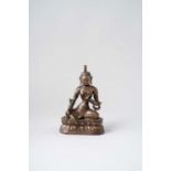 A HIMALAYAN PARCEL-GILT COPPER REPOUSSE FIGURE OF GREEN TARA 18TH/19TH CENTURY Seated in