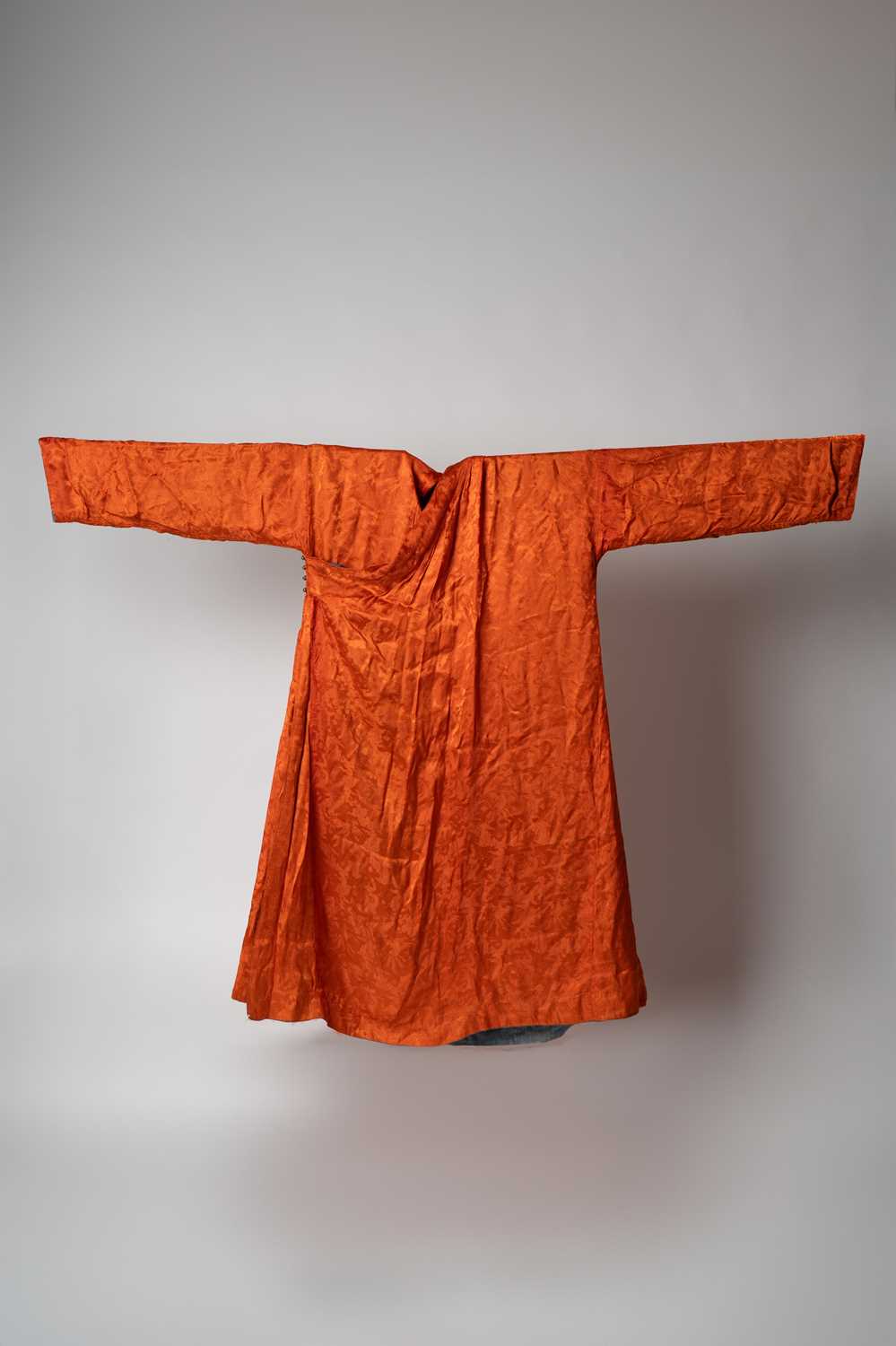 A SINO-TIBETAN ORANGE SILK BROCADE ROBE, CHUBA QING DYNASTY The robe closing on the right side and