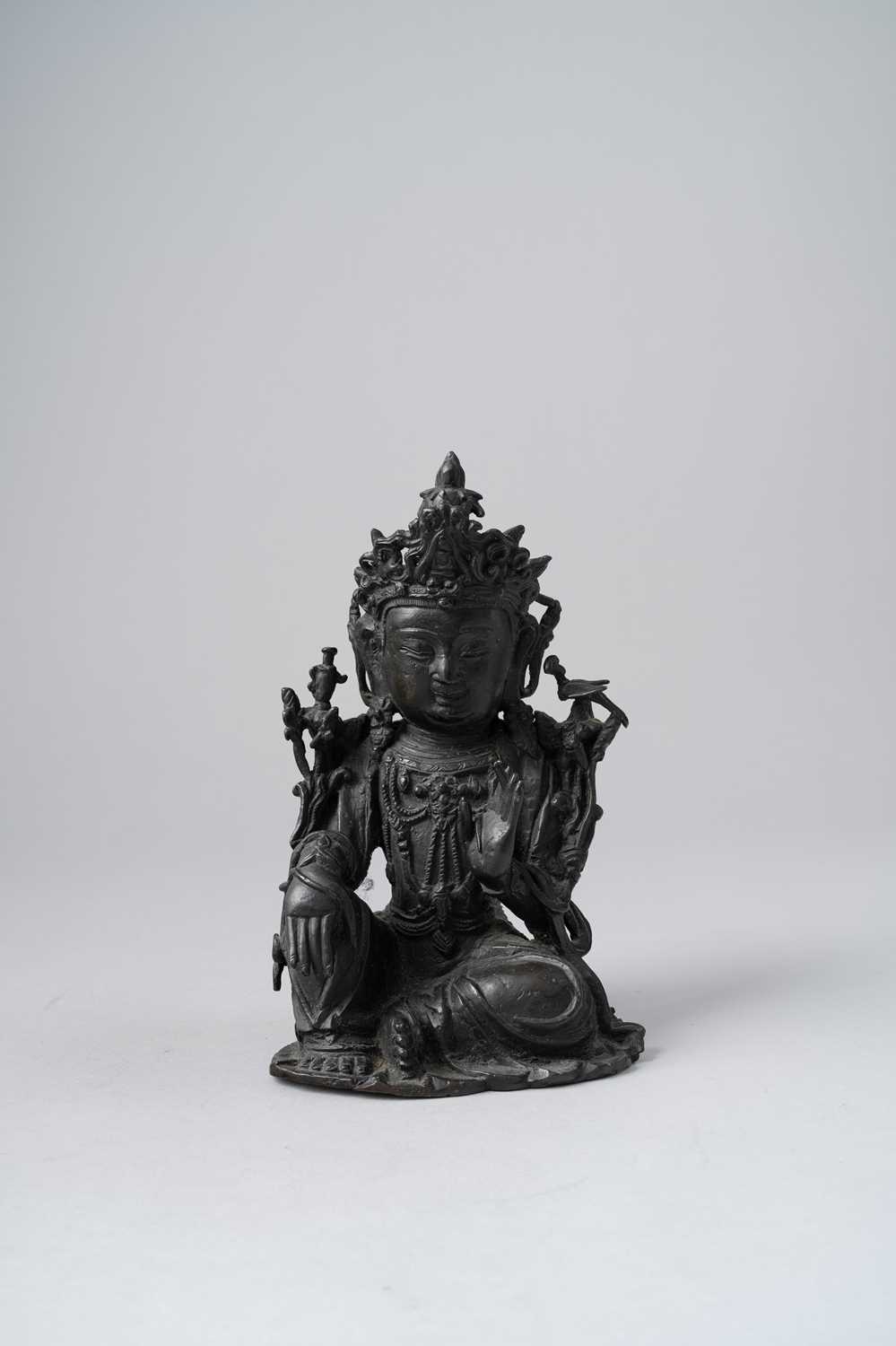 A CHINESE BRONZE FIGURE OF A BODHISATTVA LATE MING DYNASTY Seated in lalitasana, with her right hand