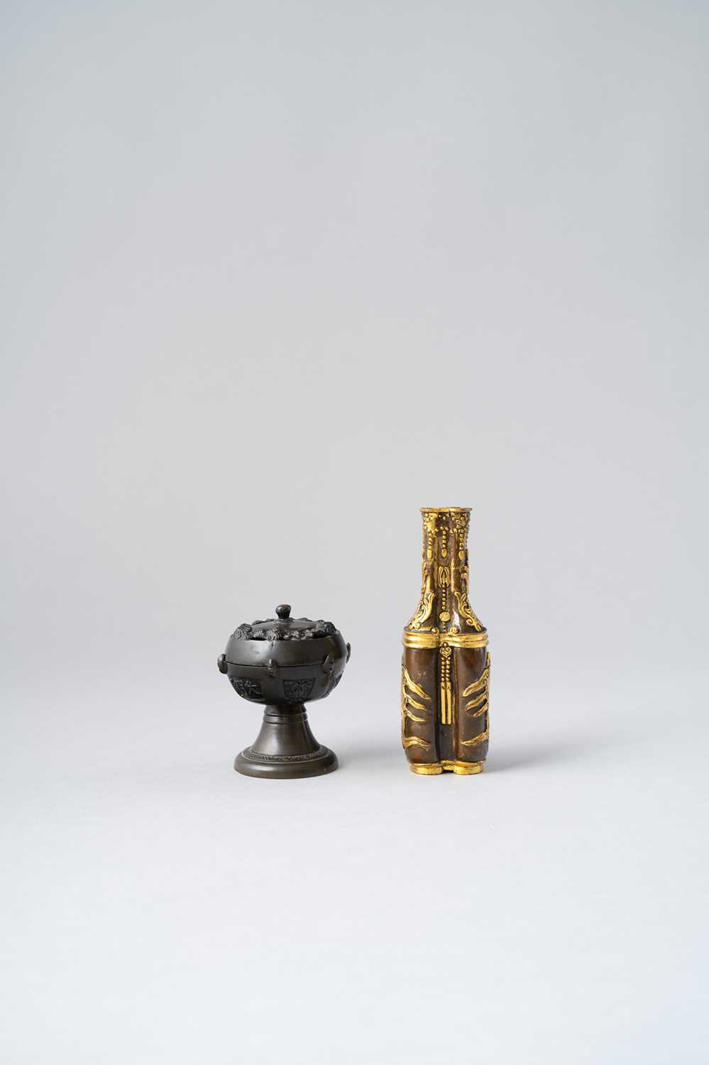 TWO CHINESE ARCHAISTIC BRONZE VESSELS 17TH CENTURY AND LATER One parcel-gilt, formed as two