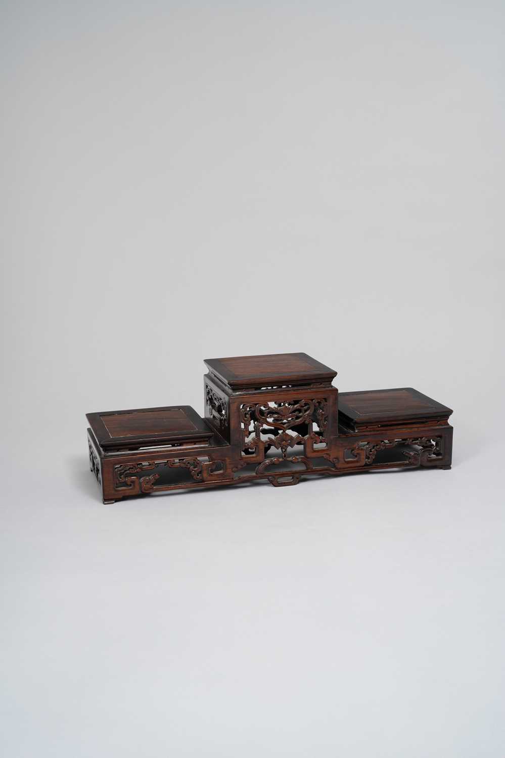 NO RESERVE A CHINESE THREE-TIERED HARDWOOD STAND LATE QING DYNASTY With square tops above a