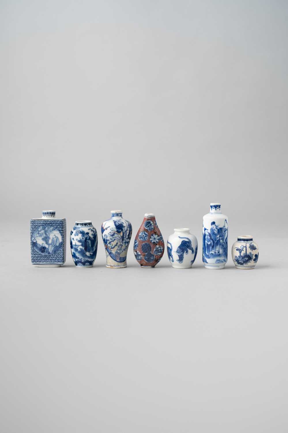 SEVEN CHINESE BLUE AND WHITE SNUFF BOTTLES QING DYNASTY One of rectangular section decorated with