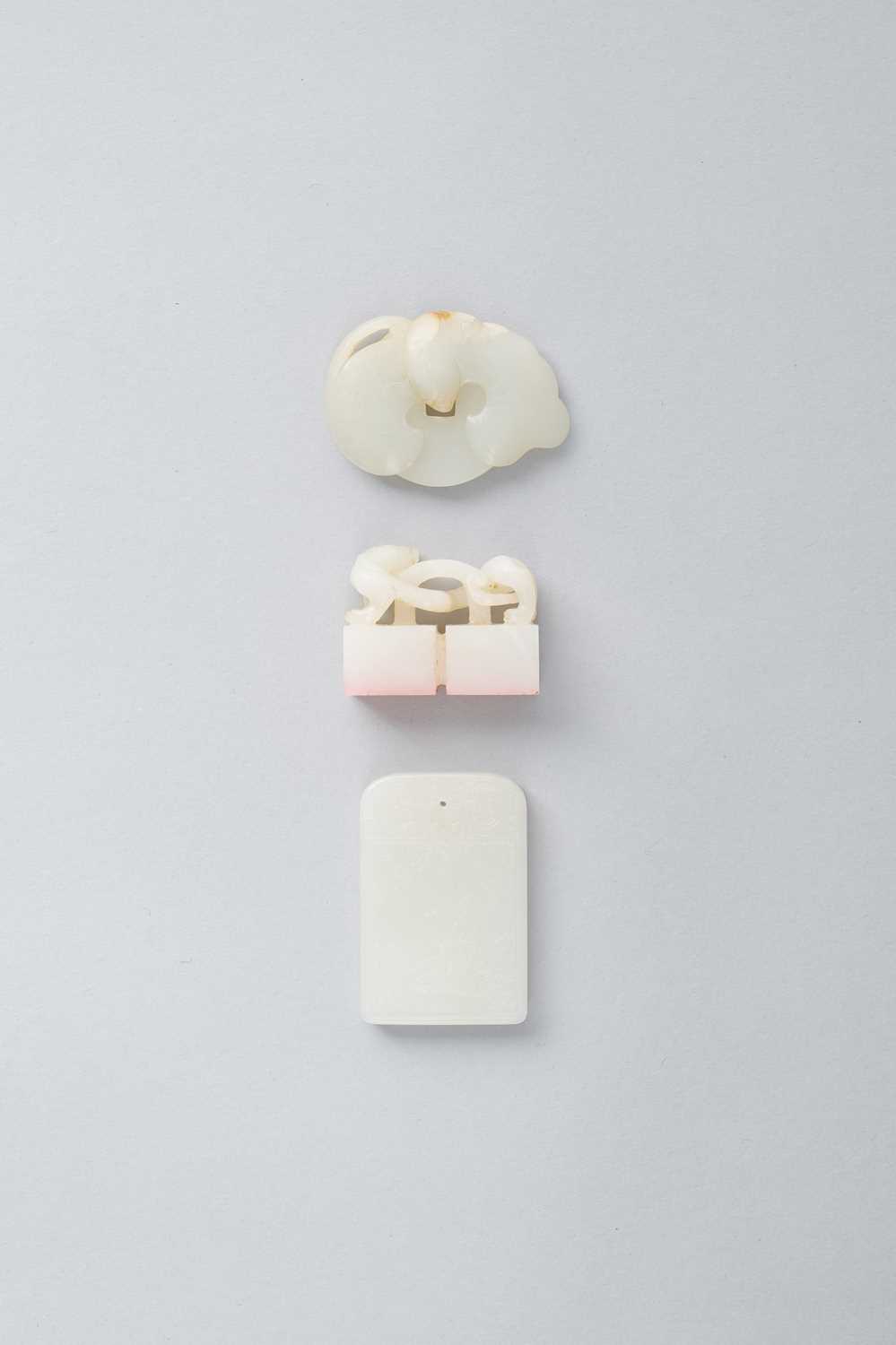 THREE CHINESE WHITE JADE ITEMS QING DYNASTY OR LATER Comprising: a rectangular plaque carved in