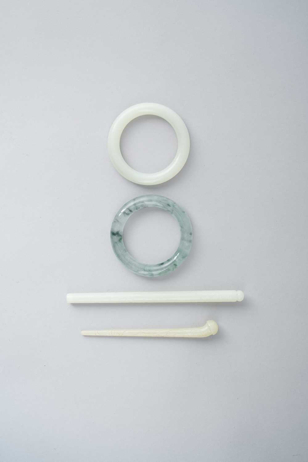 FOUR CHINESE JADE ITEMS QING DYNASTY OR LATER Comprising: a white jade bangle; a white jade brush