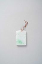 A CHINESE WHITE AND APPLE GREEN JADEITE RECTANGULAR PENDANT QING DYNASTY The pendant with a blank
