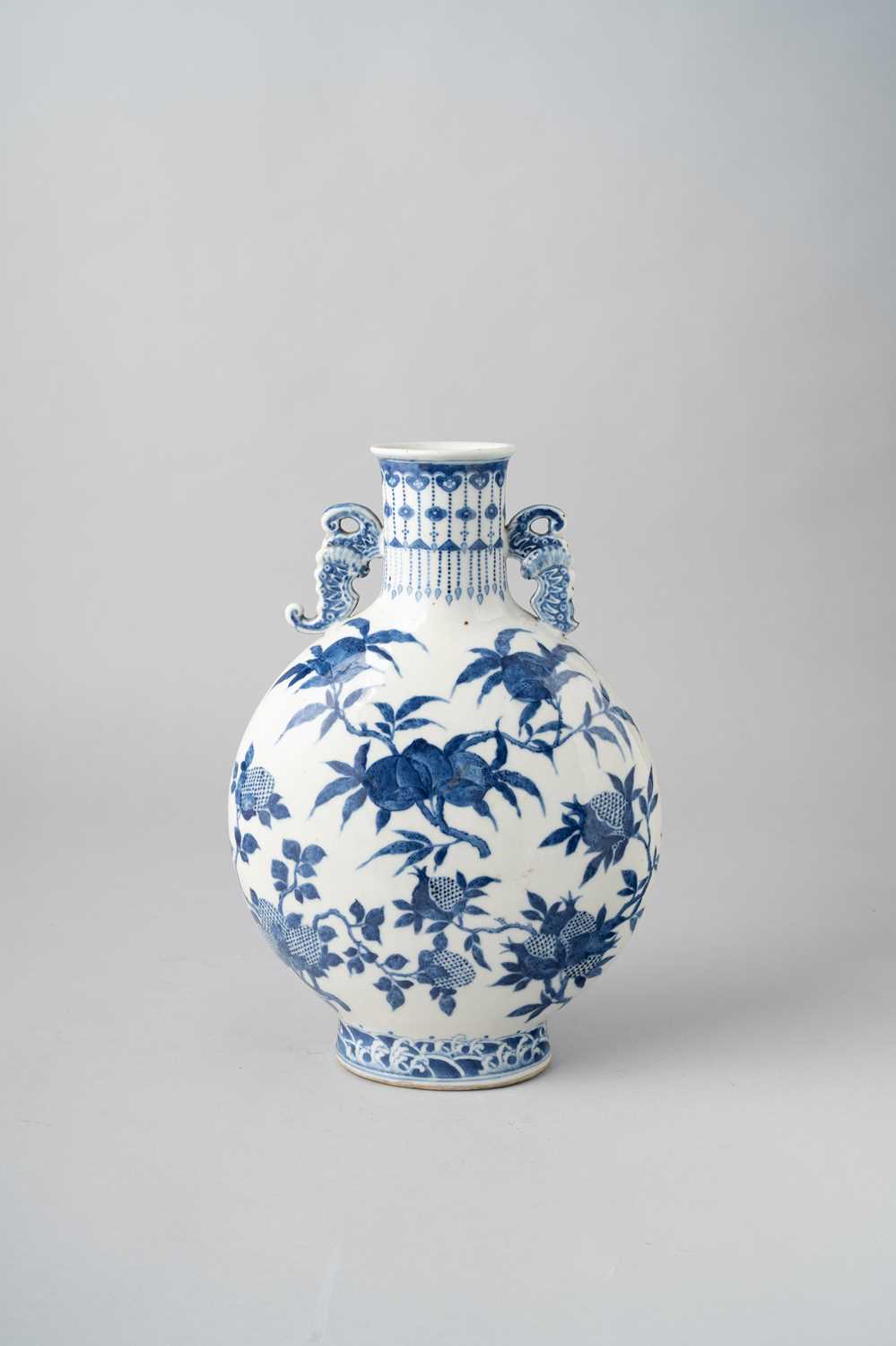 A CHINESE BLUE AND WHITE PEACH AND POMEGRANATE MOONFLASK, BIANHU 19TH CENTURY The body painted