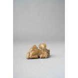 A CHINESE CELADON AND RUSSET JADE 'THREE RAMS' GROUP SONG-MING DYNASTY Depicting a large,