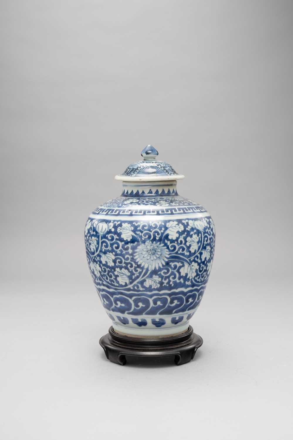 A CHINESE BLUE AND WHITE JAR AND COVER LATE MING DYNASTY Painted with bands of chrysanthemums