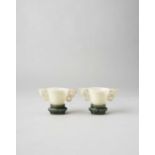 NO RESERVE A PAIR OF CHINESE WHITE JADE CUPS AND SPINACH-GREEN JADE STANDS QING DYNASTY The cups
