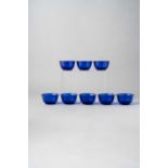 A SET OF EIGHT CHINESE BLUE BEIJING GLASS BOWLS LATE QING DYNASTY/ REPUBLIC PERIOD Each with rounded