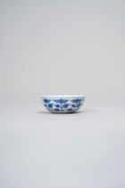 A CHINESE BLUE AND WHITE SHALLOW CUP XUANTONG, DATED 1909 The rounded sides decorated with eight