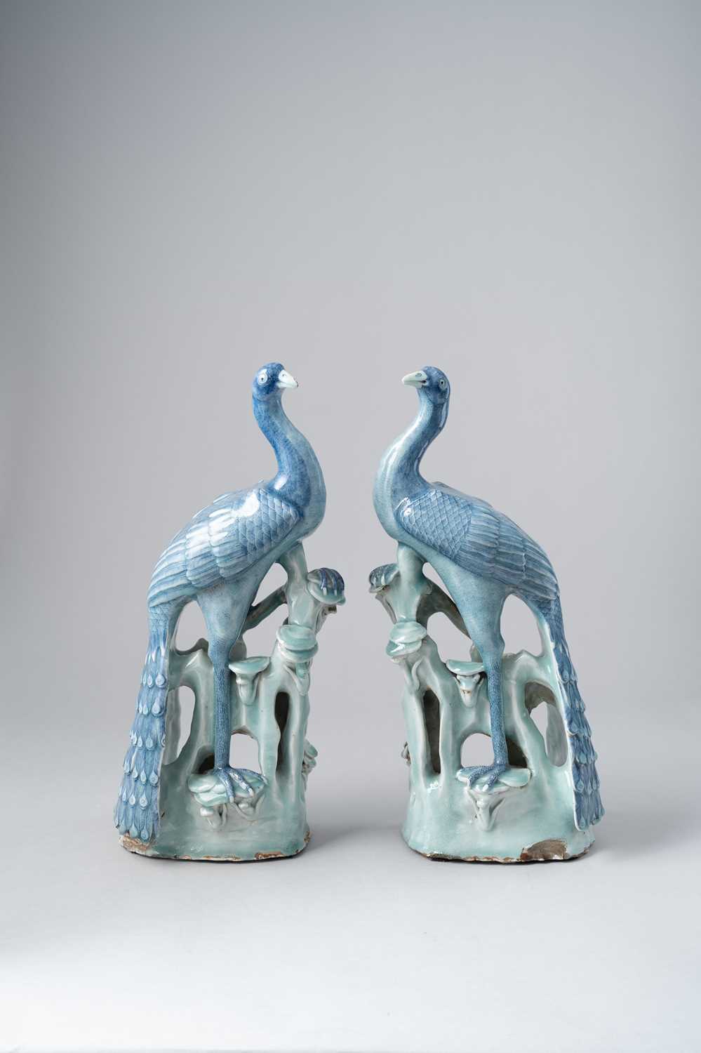 A LARGE PAIR OF CHINESE BLUE AND CELADON GLAZED PEACOCKS 19TH CENTURY Each bird decorated with