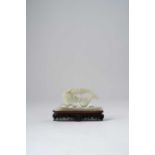 A CHINESE CELADON JADE CARVING OF A CARP QING DYNASTY Emerging from rolling waves, its upturned body