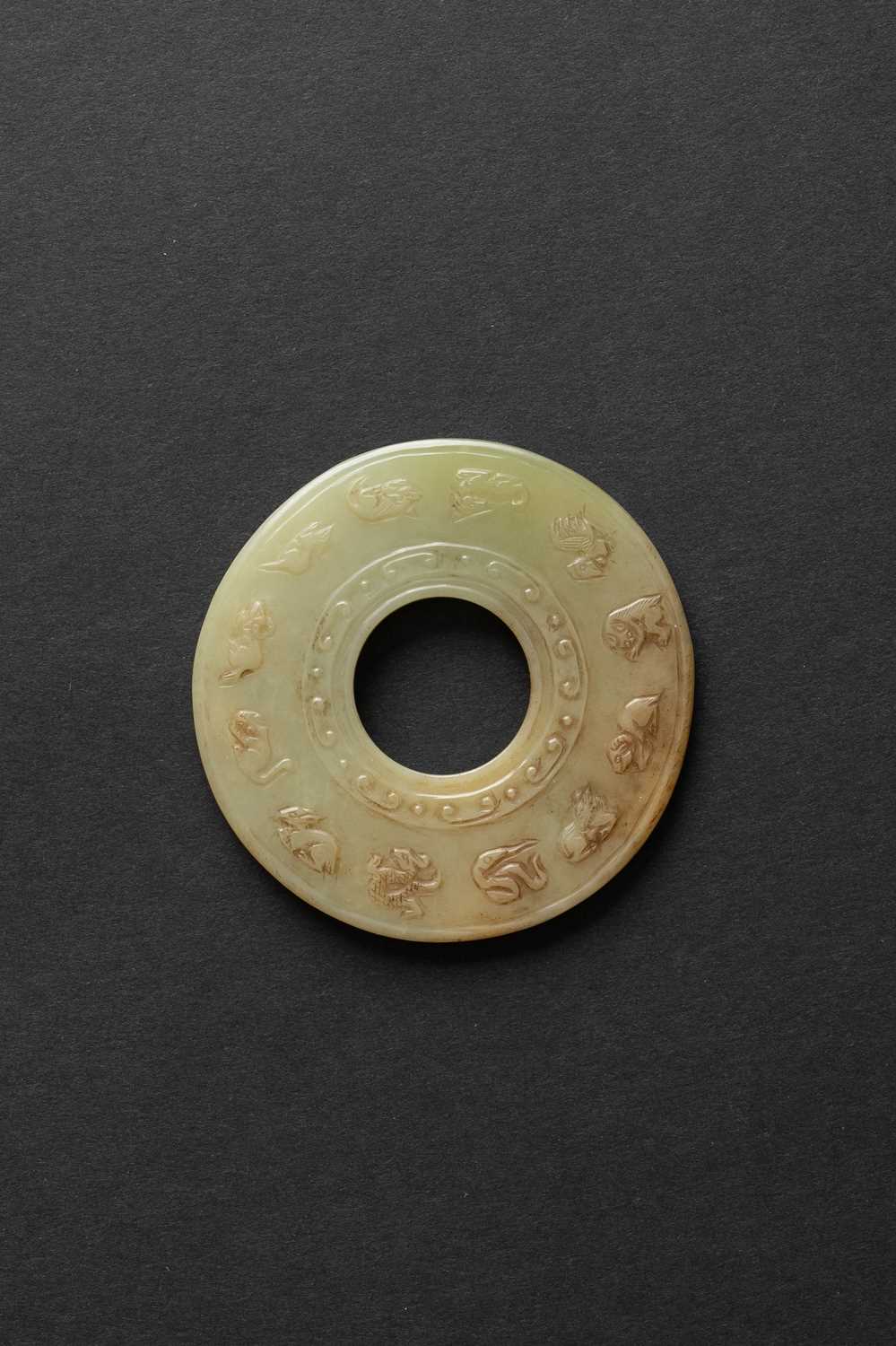 A CHINESE YELLOW JADE 'ZODIAC' DISC, BI QING DYNASTY Carved with the zodiac animals to one side