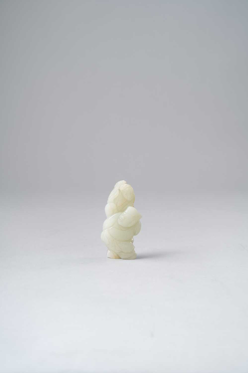 A CHINESE PALE CELADON JADE FIGURAL PENDANT QING DYNASTY Depicting a man in scholar's robes and a