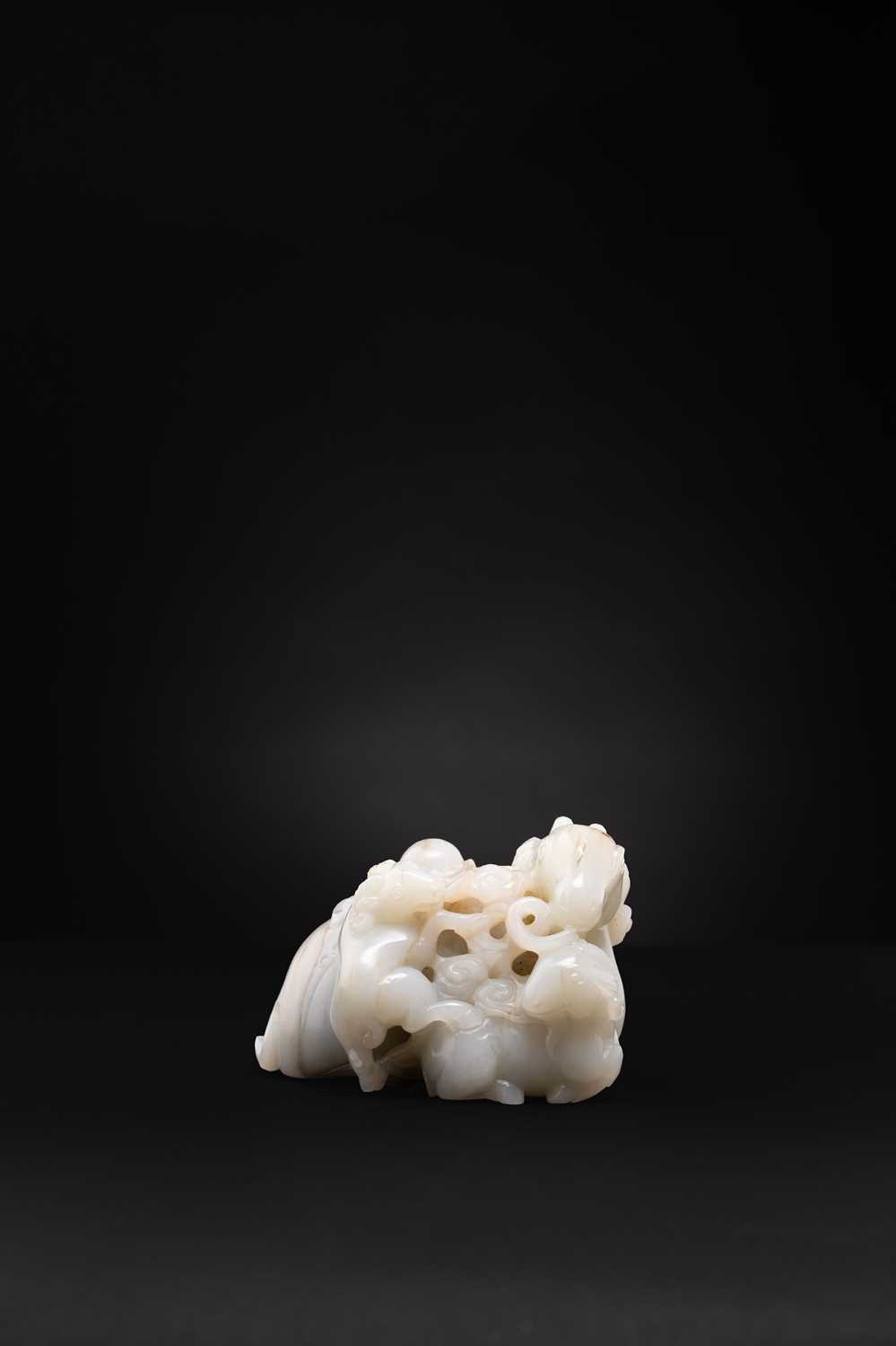 A CHINESE PALE CELADON JADE 'THREE RAMS' GROUP QING DYNASTY Carved as a large recumbent ram