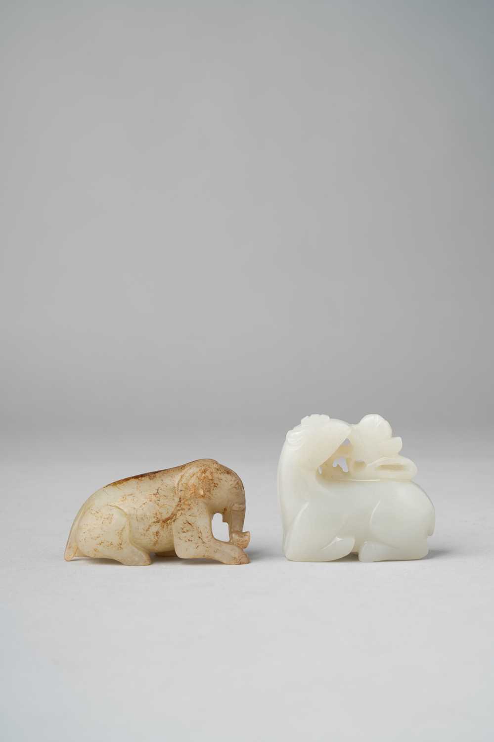 TWO CHINESE JADE CARVINGS OF ANIMALS QING DYNASTY OR LATER One a white jade carving of a deer with a