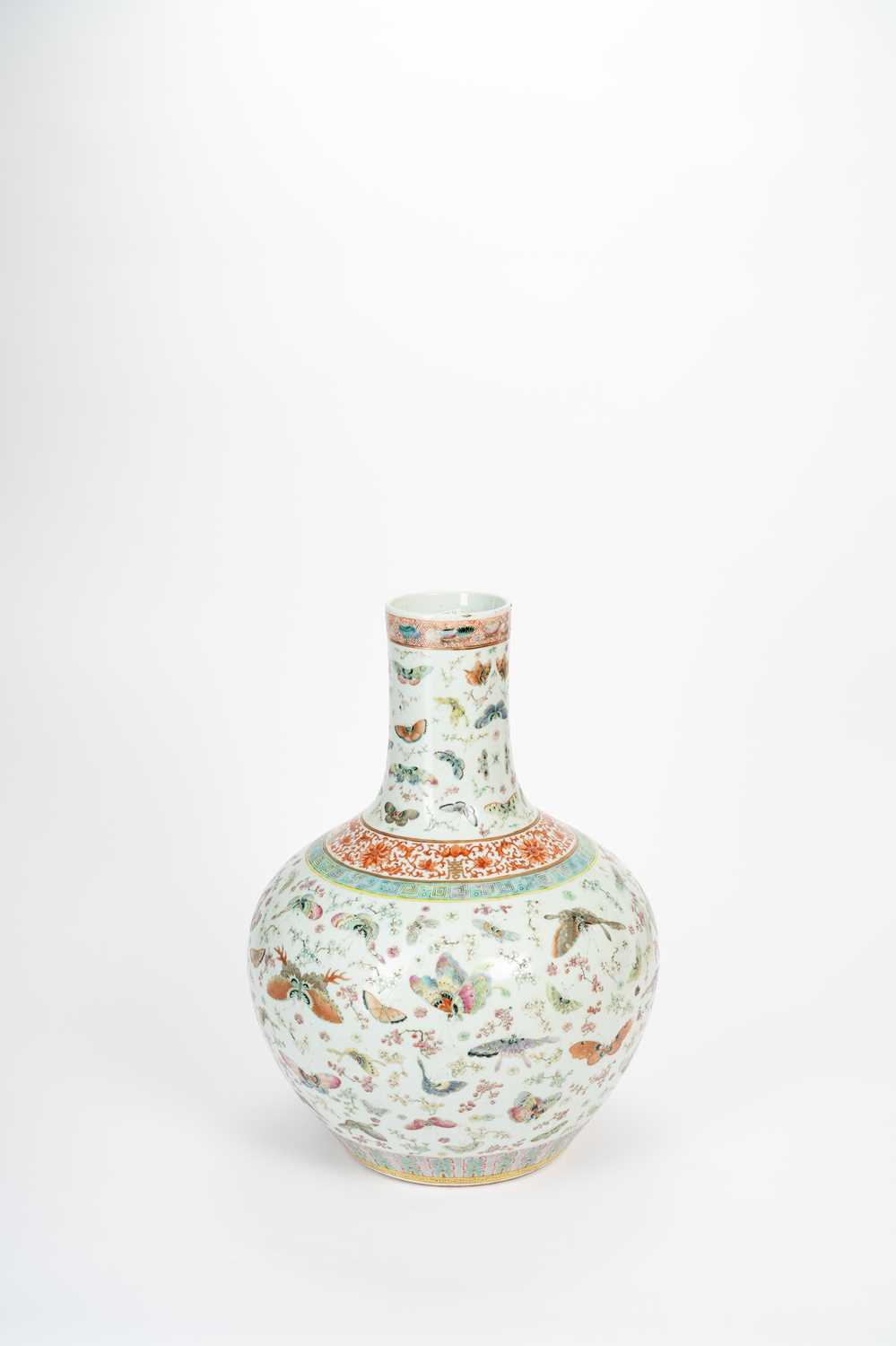 A CHINESE FAMILLE ROSE 'BUTTERFLY AND PRUNUS' BOTTLE VASE 19TH CENTURY Brightly enamelled with