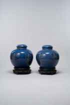 A PAIR OF CHINESE BLUE-GROUND 'FU SHOU' JARS AND COVERS SIX-CHARACTER QIANLONG MARKS AND LATE IN THE