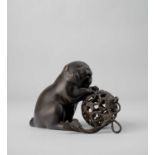 A JAPANESE BRONZE OKIMONO OF A PUPPY WITH A BROCADE BALL MEIJI ERA, 19TH/20TH CENTURY The plump