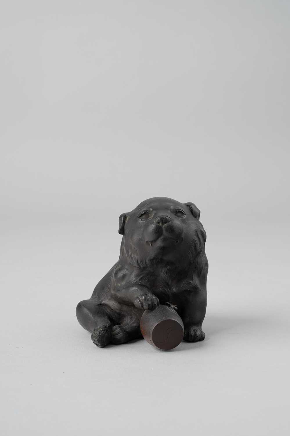 A JAPANESE BRONZE OKIMONO OF A PUPPY WITH A DRUM MEIJI ERA, 19TH/20TH CENTURY The charming plump dog