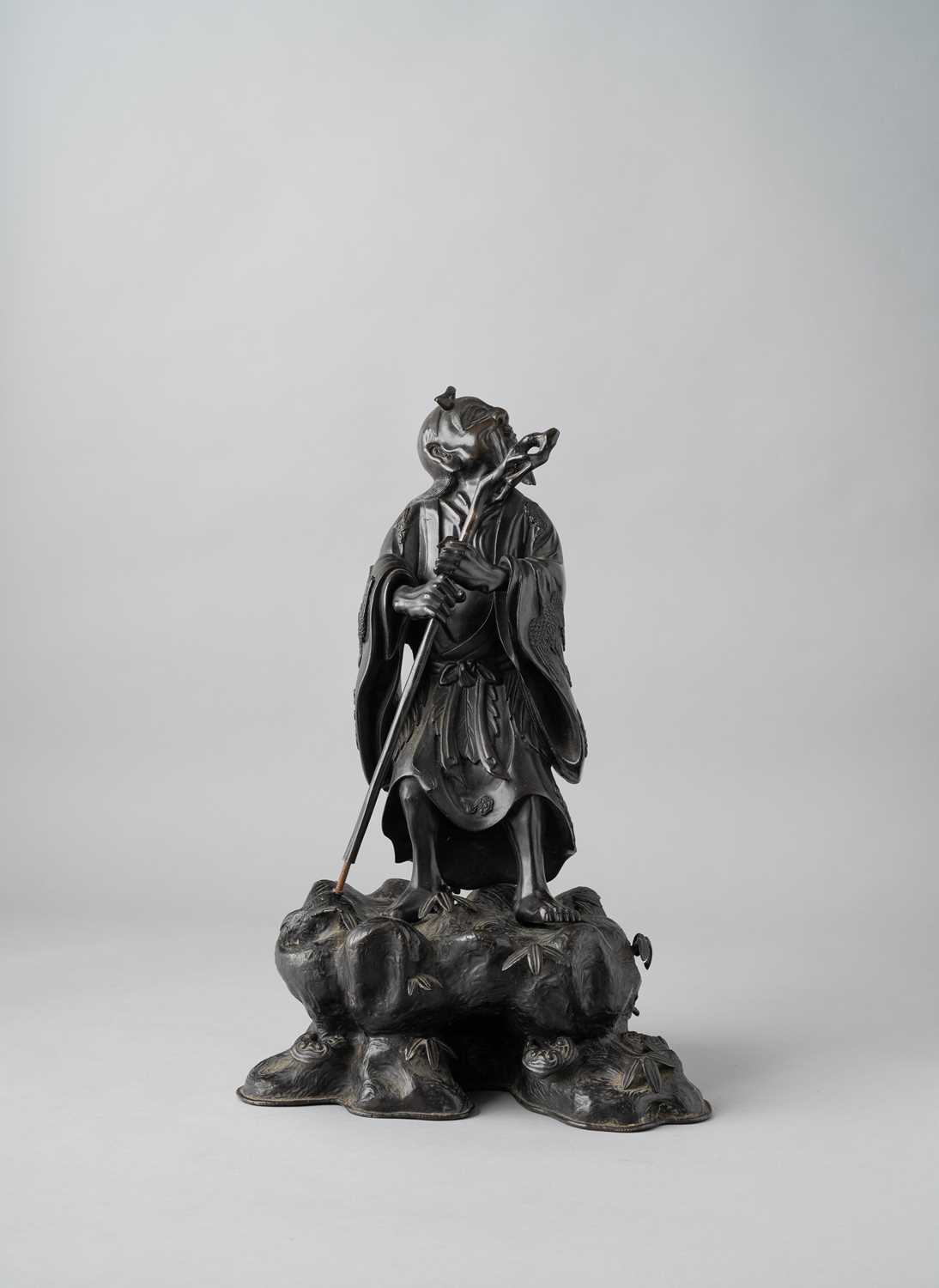 A LARGE JAPANESE BRONZE OKIMONO OF A SENNIN MEIJI ERA, 19TH CENTURY The sage is depicted wearing a