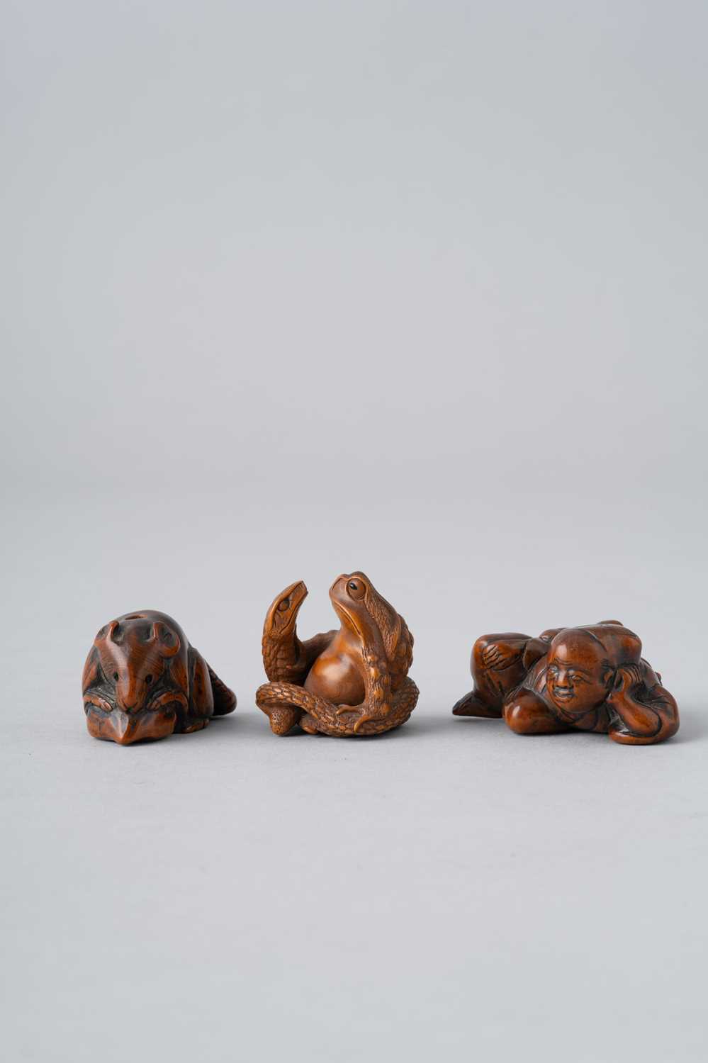 THREE JAPANESE WOOD NETSUKE EDO AND MEIJI, 18TH AND 19TH CENTURY One carved as a small rat gnawing