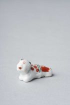 A SMALL JAPANESE KAKIEMON-STYLE WHISTLE EDO PERIOD, C.1700 Modelled as a small boy lying on his