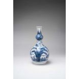 A TALL JAPANESE BLUE AND WHITE ARITA VASE EDO PERIOD, 17TH CENTURY The double gourd-shaped body with