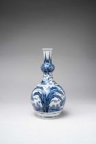 A TALL JAPANESE BLUE AND WHITE ARITA VASE EDO PERIOD, 17TH CENTURY The double gourd-shaped body with